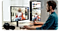 A designer is editing photos on dual screens.