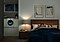It’s night time. The couple is sleeping in their bedroom while the QuickDrive™ is washing close in the next room. The lights on the QuickDrive™ are on and the machine is running smoothly and quietly so they can sleep peacefully.