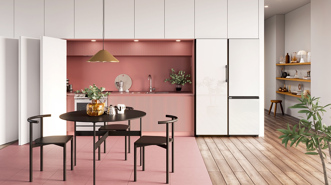 A Glam White panel 1-door Bespoke refrigerator is built into a stylish cabinet in a modern kitchen next to a 2-door unit of the same color.