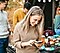 A woman texting during a party with Bixby’s assistance.