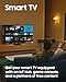 A man is viewing the Smart Hub home screen displayed on his Smart TV. The text Get your smart TV equipped with an IoT Hub, game console, and a plethora of free content is featured at the bottom.