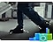 A person's feet are shown sideways and in a close-up, as he/she is carrying a white appliance on a trolley to be recycled. There are illustrations of devices and appliances in green and blue hues on the bottom right along with white illustrations of particles moving with the person's feet.