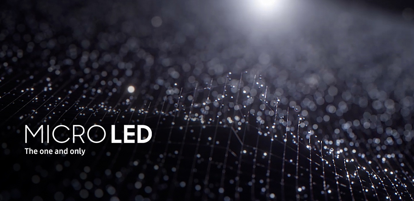 Simulated Micro LEDs fly-in and re-illuminate various elements of nature scenes, including a forest tree, the mushrooms of a tree trunk, an exotic red flower and the scales of a lizard. A particle of light flies into the Micro LED's elements and back out again. The camera zooms into image, showing again the Micro LED with an image of liquid colors mixing together.