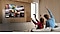A child and a parent are joyfully engaged in a game on TV, with three KartRider characters displayed on the screen.