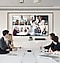 attending a video conference in the conference room.