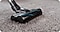 It is cleaning on gray carpet with Samsung Cordless vacuums.