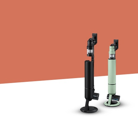 A female sits in an office setting holding a phone in her hand and speaking into it.