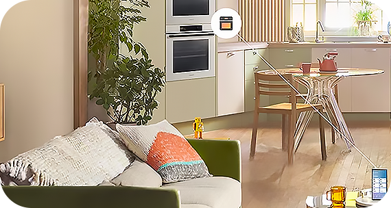 Smartfon stojący na stoliku kawowym połączony linią z inteligentnym piekarnikiem do zabudowy