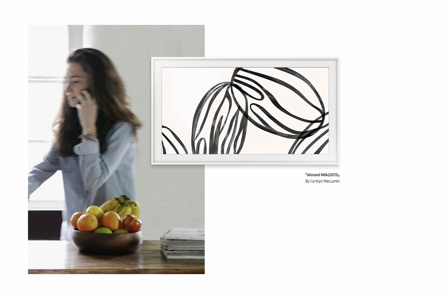 The Frame, care prezintă o lucrare de artă intitulată „Almond Milk (2013) de Carolyn MacLaren” este suprapus peste blatul bucătăriei cu un coș cu fructe.