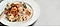 The Recipe: Creamy risotto made with roasted butternut squash, woody spices, parmesan and a splash of white wine is on an white plate.