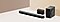 يوجد جهاز الصوت soundbar ومكبرا صوت خلفيان وجهاز مضخم صوت أمام جدار بيج.