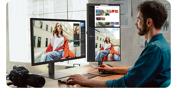 A designer is editing photos on dual screens.