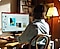 A woman is looking at a monitor and working on a product photo.