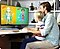 The father and the child are learning while looking at the monitor.