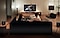 A couple escapes into a movie in their living room, complete with Samsung TV and Soundbar.