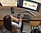 A birds-eye view of a lady sitting at a desk and working remotely a breeze using Samsung’s DeX app to connect mobile device to desktop monitor.