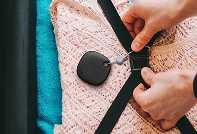 SmartTag being placed on a luggage