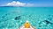 A man sitting on a boat is looking at the blue sea, and the scene was taken as beach holiday pictures.