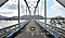 Subject is seen crossing a bridge at 0.6 times zoom. Then, 1 times zoom, 2 times zoom, 3 times zoom, 5 times zoom, 10 times zoom, 30 times zoom, 50 times zoom, 70 times zoom, 100 times zoom and then back down to 10 times zoom. Whether zoomed in or out, the details remain clear.