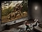 Two youngsters donning animal costumes are engrossed in watching two dinosaurs on Samsung's expansive Supersize display in the living room.