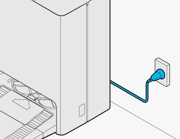 Plugging the power cord of the Clean Station into an electrical outlet, positioned near the base of the unit on an even floor.