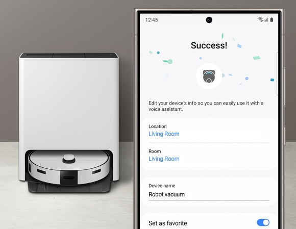 Phone screen displays 'Success!' in the SmartThings app, showing settings for a robot vacuum named 'Robot vacuum' in the living room, with a Samsung Jet Bot Combo in the background.