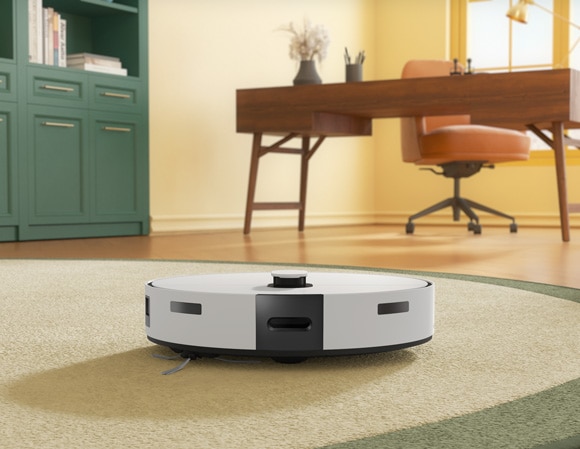 Samsung Jet Bot Combo model VR7MD96*14* on a beige rug in a home office setting, with a green cabinet and a wooden desk in the background.