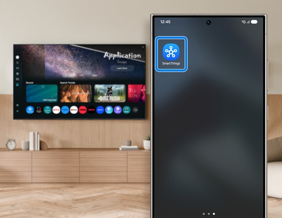 Samsung phone with SmartThings app icon onscreen, in front of a blurred TV in a living room.