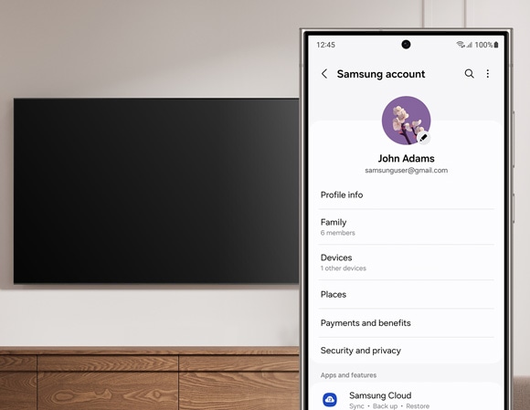 Phone screen showing a Samsung account, with a Smart TV in the background, ready for Wi-Fi connection setup.