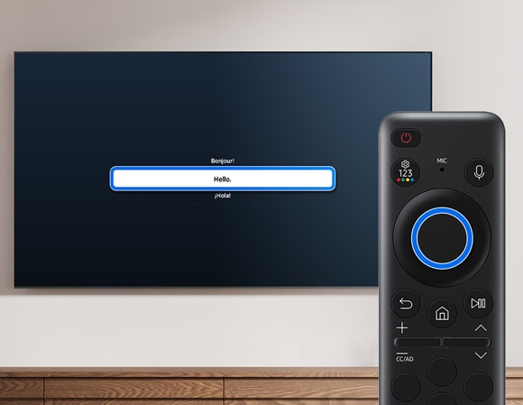 Samsung TV displaying language options 'Bonjour', 'Hello', and 'Hola' with a remote control in the foreground.