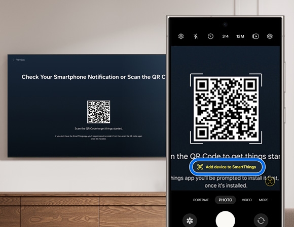 Phone camera focused on a QR code on a Samsung TV screen for setup via the SmartThings app.