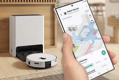 Phone controlling a Samsung Jet Bot Combo through the SmartThings app, displaying the vacuum's cleaning path.