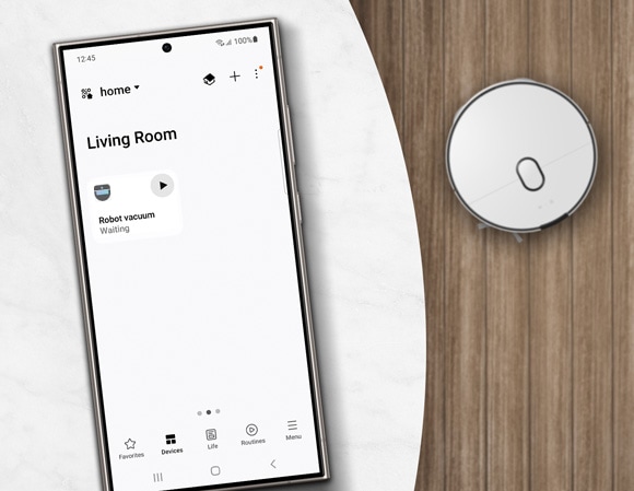 Phone screen showing the SmartThings app with a robot vacuum ready to start cleaning in the living room.