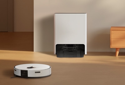 Samsung Jet Bot Combo robotic vacuum cleaner in a living room, with its charging dock in the background.