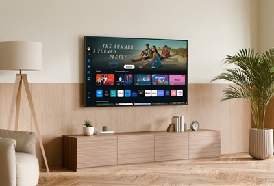Modern living room with a Samsung Smart TV displaying the Smart Hub interface on the screen, showcasing various streaming apps.