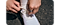 A pair of hands are tying shoe laces. The finger is wearing the Galaxy Ring.