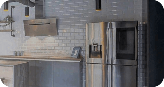 A modern kitchen featuring stainless steel appliances, including a sleek refrigerator.