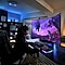 A man sitting in front of a Samsung Odyssey G30D gaming monitor playing games.