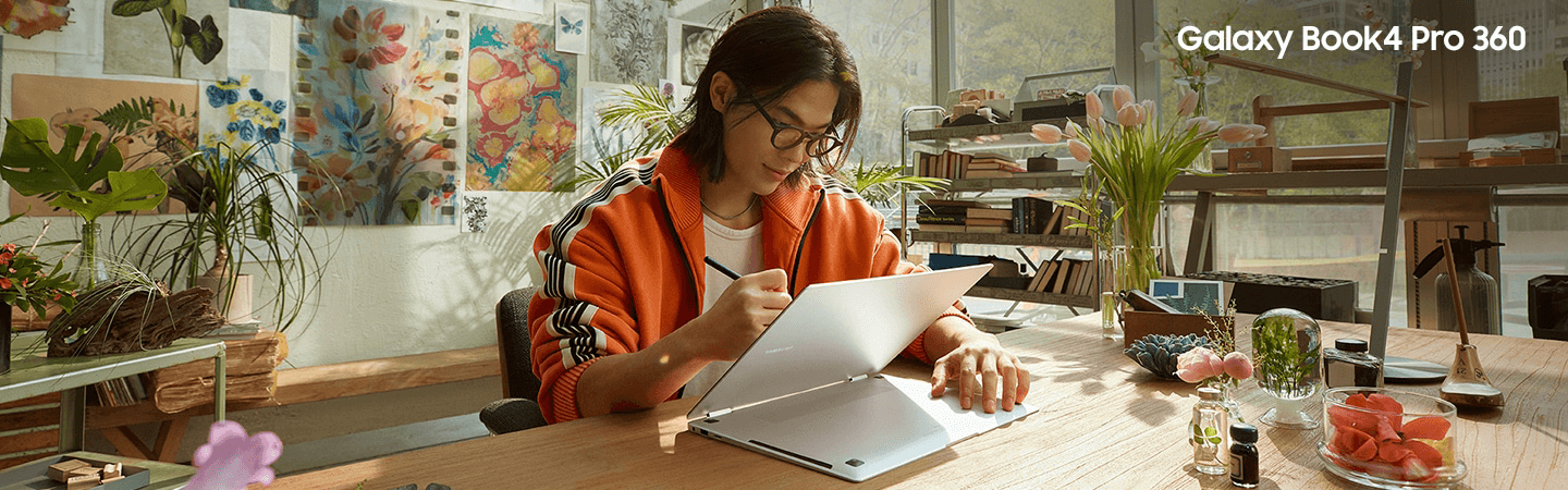 A female is shown in an office setting looking at a Galaxy tablet