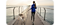 A woman is running along a peir with her dog on a lead, while listening Galaxy Buds2 Pro.