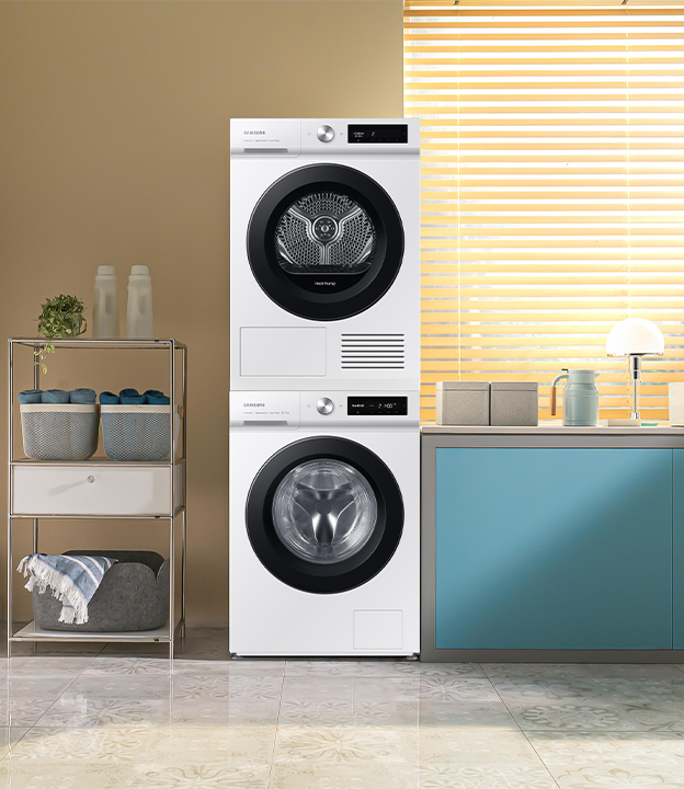 The Bespoke AI laundry and dryer are in a room with yellow cabinets and placed on top of each other. The Bespoke AI laundry and dryer are in a room with yellow cabinets and placed on top of each other.