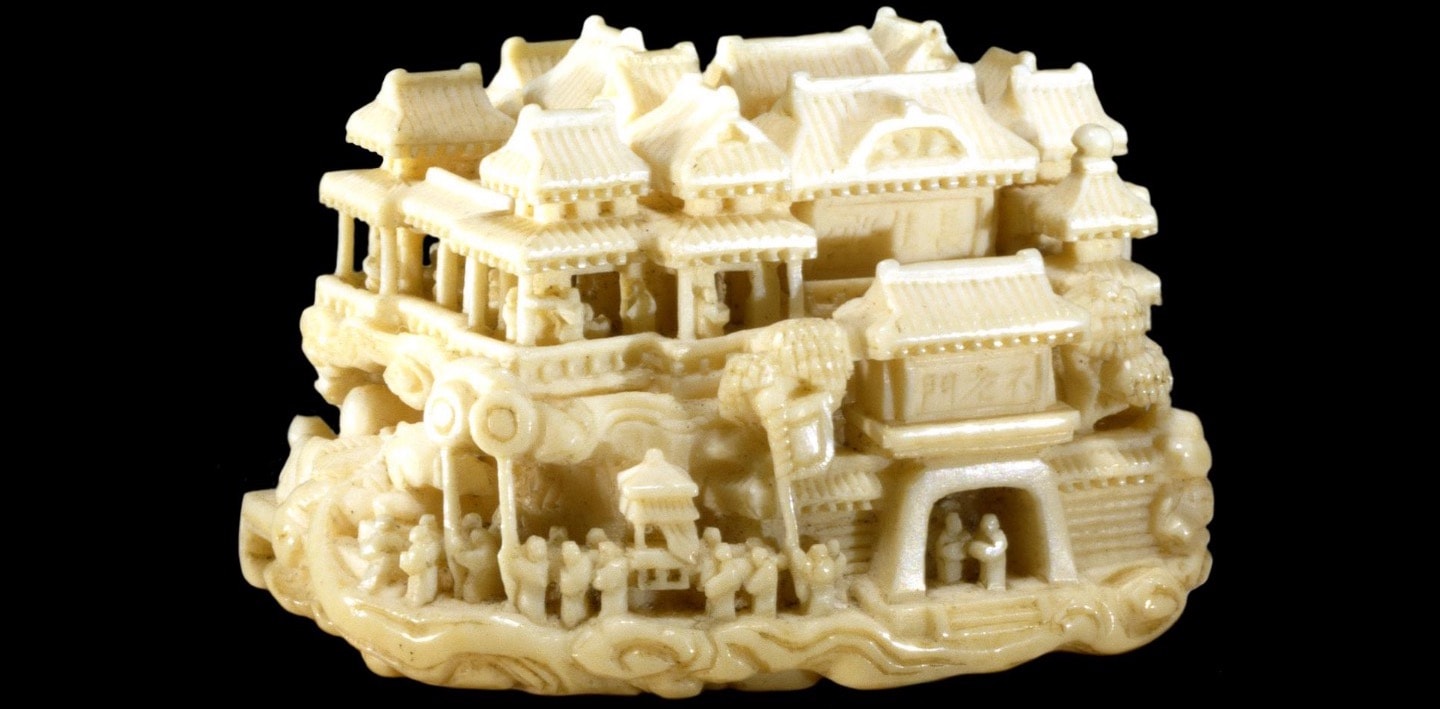 Photo of a small ivory Asian palace in front of a black background Photo of a small ivory Asian palace in front of a black background