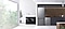 There is a Samsung Bespoke refrigerator, washer, dryer, dishwasher in a sunlit kitchen, next to a window with views of trees.