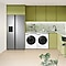 Fridge freezer and laundry appliances embedded with green cabinets in a kitchen