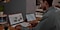 A man sitting down at a desk with Samsung laptop and a Galaxy Tab tablet