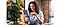 A girl sitting down drinking coffee whilst using her samsung galaxy Tab