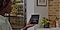 A women holding Samsung Galaxy Z Fold 3 5G with one hand showing sunset photo on unfolded screen