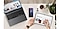 Various Galaxy devices are on a table with a cup of coffee and a plant: a Galaxy Book, a Samsung Galaxy smartphone, Galaxy Buds and a Galaxy Tab. A person's hands are partially visible, with a Galaxy Watch on one wrist. The other hand holds an S Pen, drawing on the Galaxy Tab while referencing content on the Galaxy Book. The smartphone shows the Nearby devices GUI, displaying connected devices as icons.