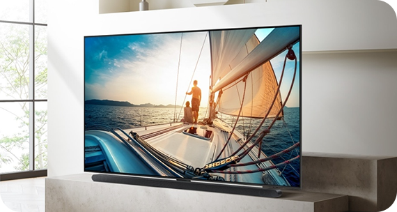 A Samsung TV is stood on a table in a living room setting.