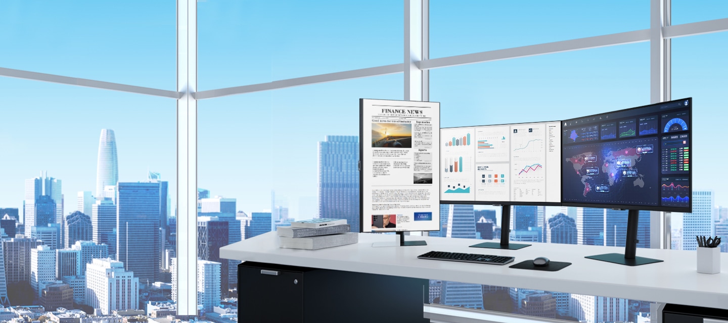 Three Samsung Monitors are shown on a desk overlooking a city landscape